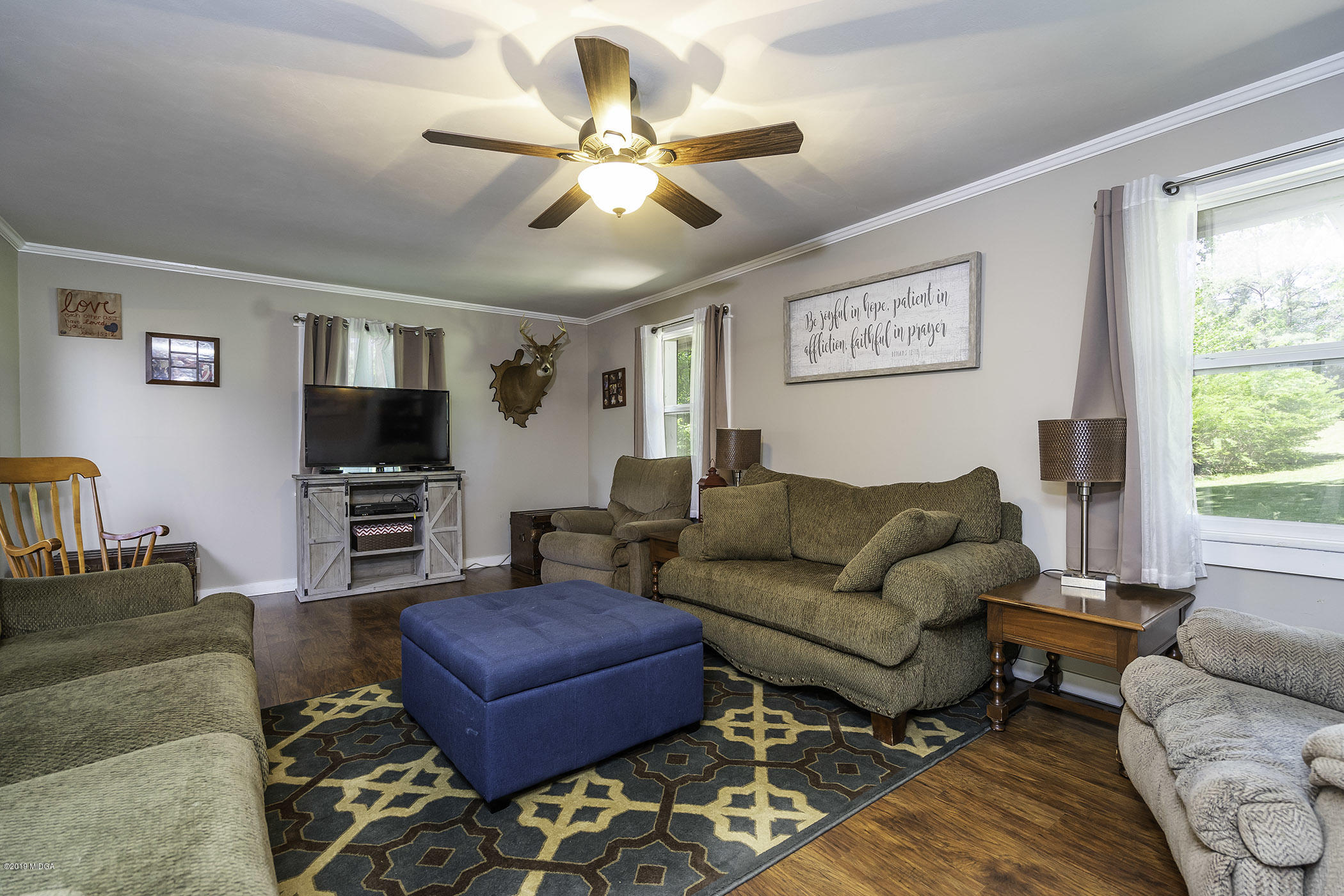 1613 Dames Ferry Road Forsyth, GA 31029 - Photo 4 of 23 a living room with furniture a ceiling fan and a window