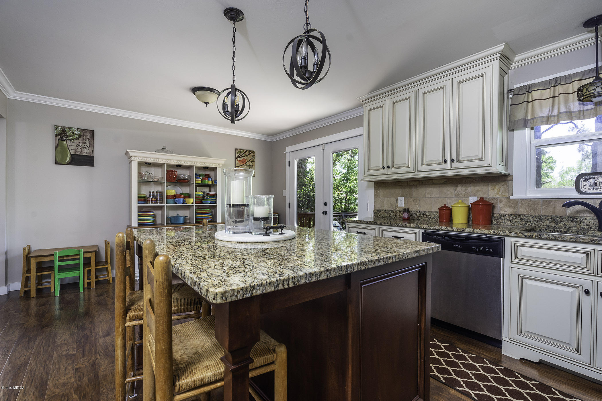 1613 Dames Ferry Road Forsyth, GA 31029 - Photo 6 of 23 a kitchen with stainless steel appliances granite countertop a sink a stove and a wooden floors