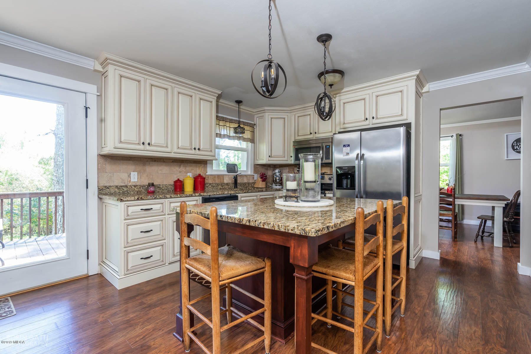 1613 Dames Ferry Road Forsyth, GA 31029 - Photo 7 of 23 a kitchen with stainless steel appliances granite countertop a sink a stove a refrigerator and wooden floor