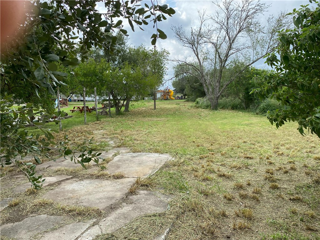 806 West 3rd Street Bishop, TX 78343 - Photo 3 of 4 a view of a yard with trees