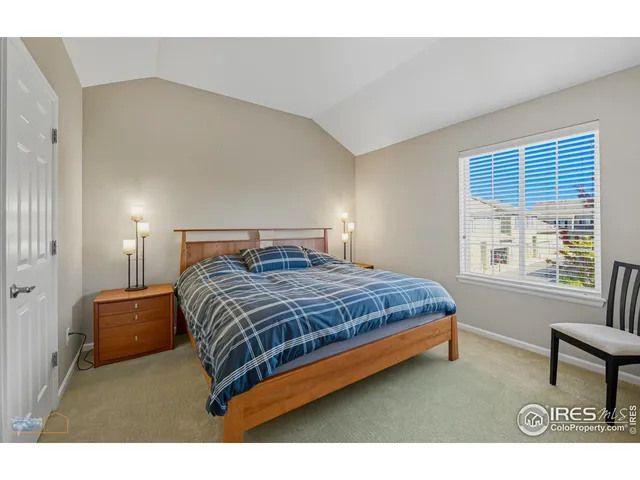 a bedroom with a bed a table and chair