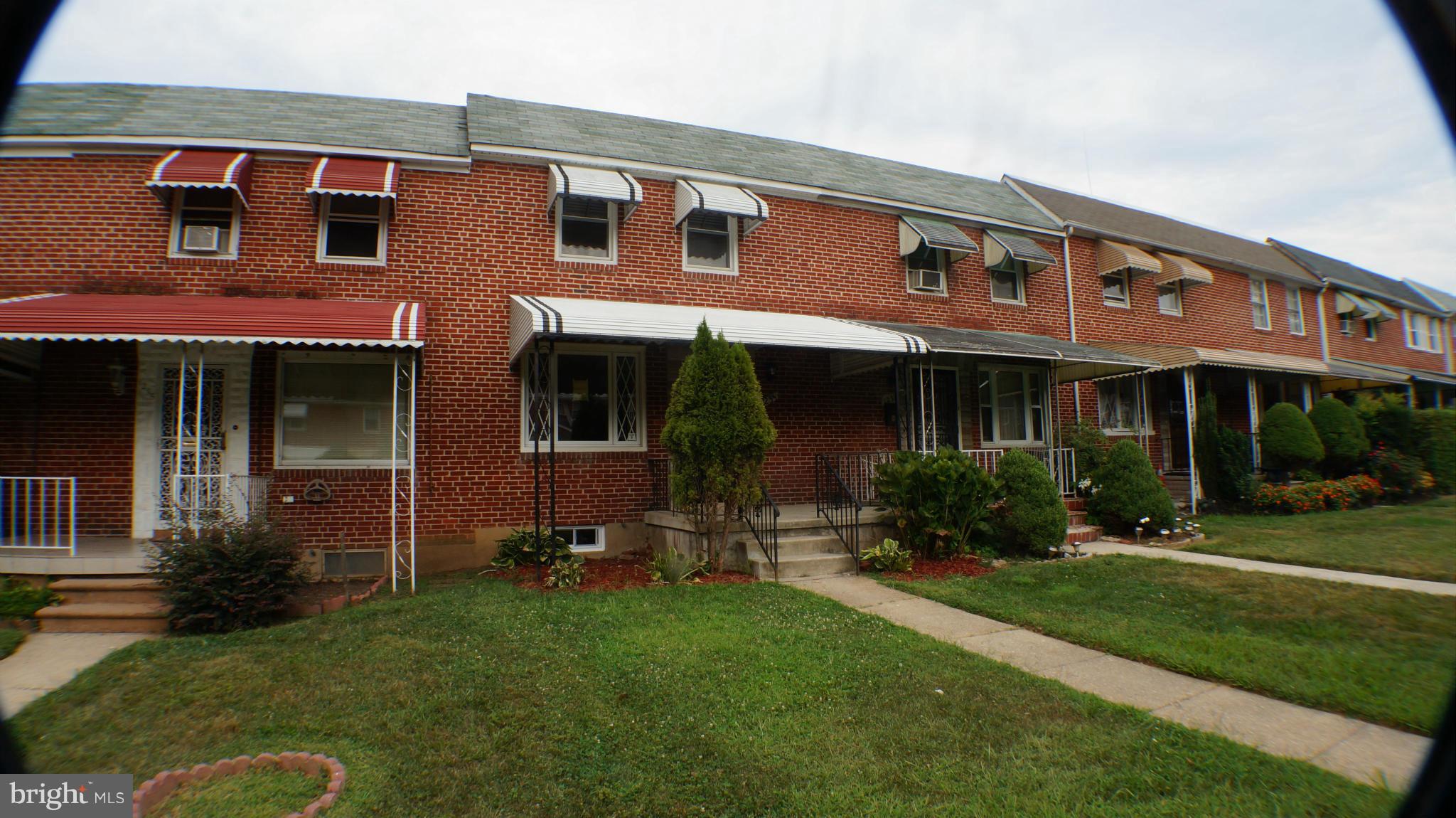 1233 Kevin Road Baltimore, MD 21229 - Photo 1 of 22 front view of a brick house with a yard