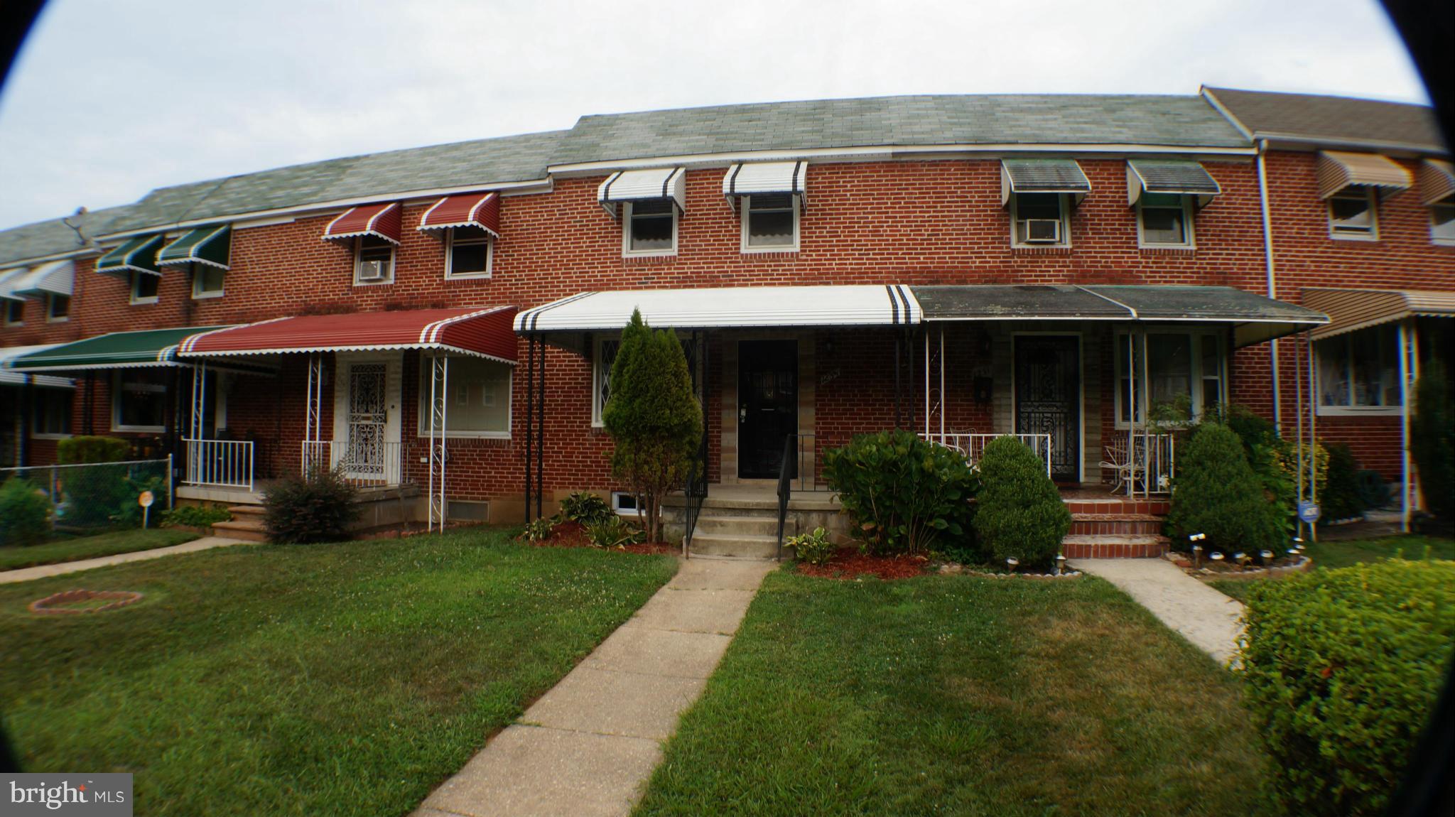 1233 Kevin Road Baltimore, MD 21229 - Photo 2 of 22 a front view of a house with a yard