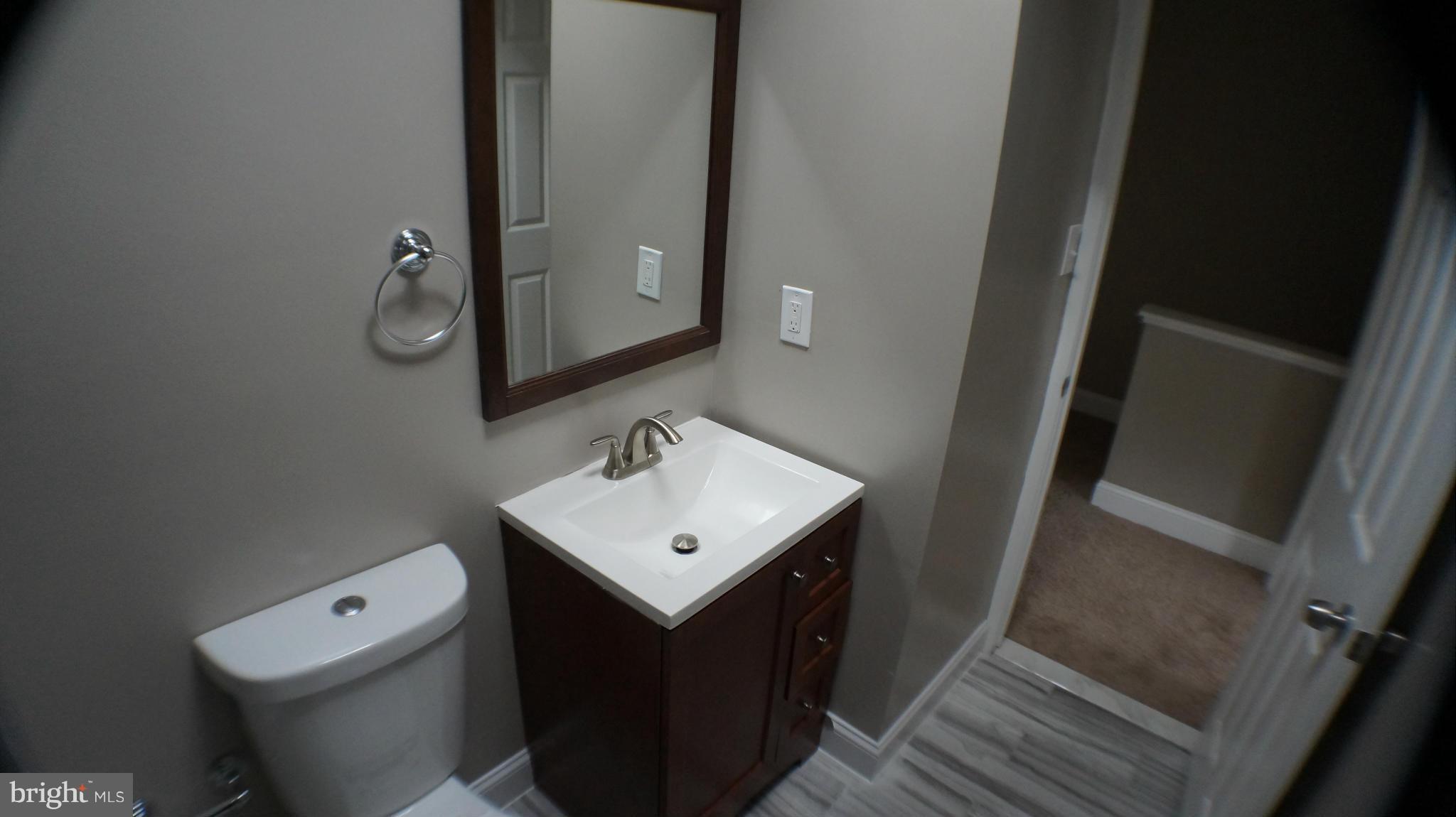 1233 Kevin Road Baltimore, MD 21229 - Photo 14 of 22 a bathroom with a sink toilet and mirror