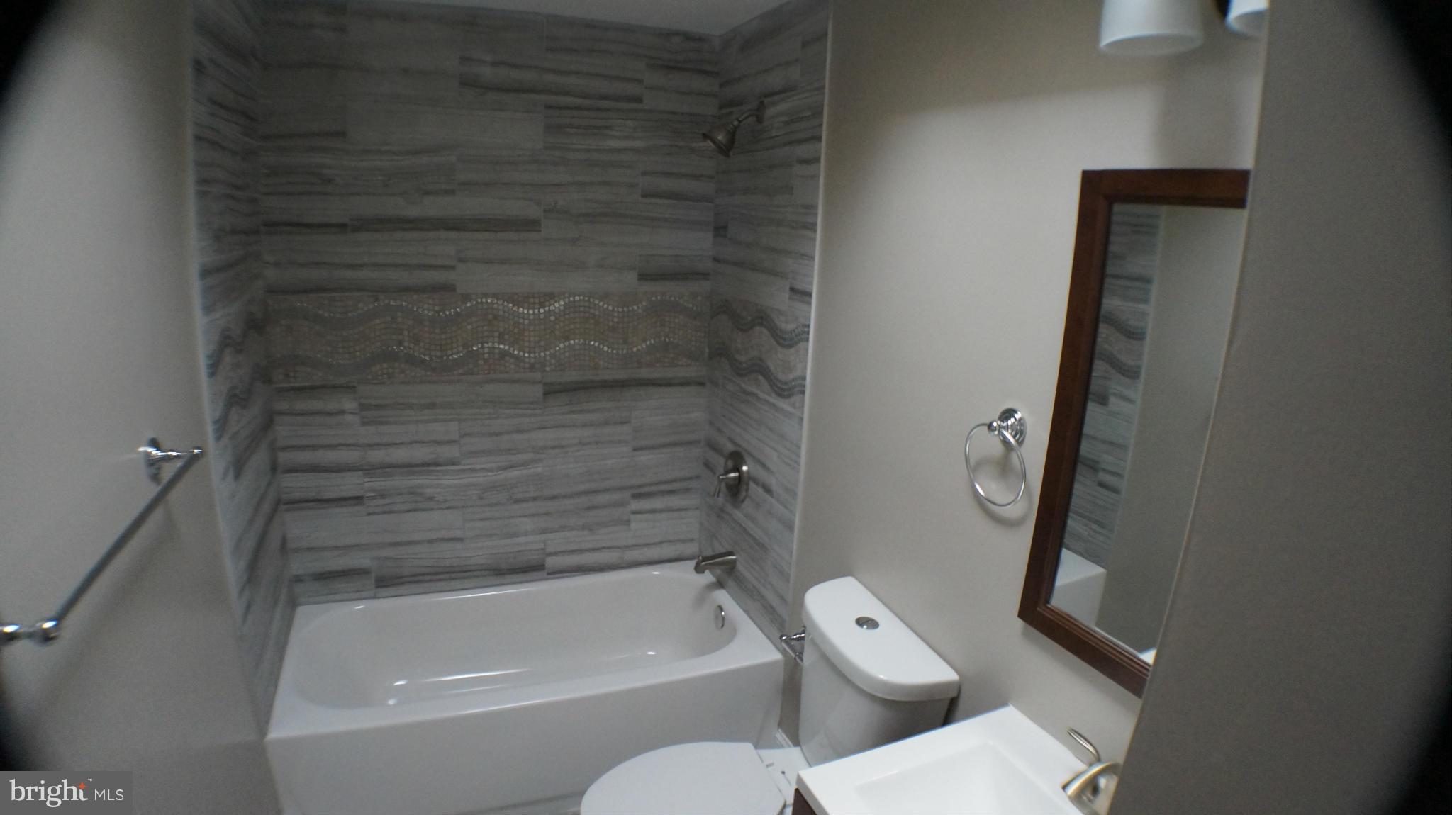 1233 Kevin Road Baltimore, MD 21229 - Photo 15 of 22 a bathroom with a toilet and a bath tub