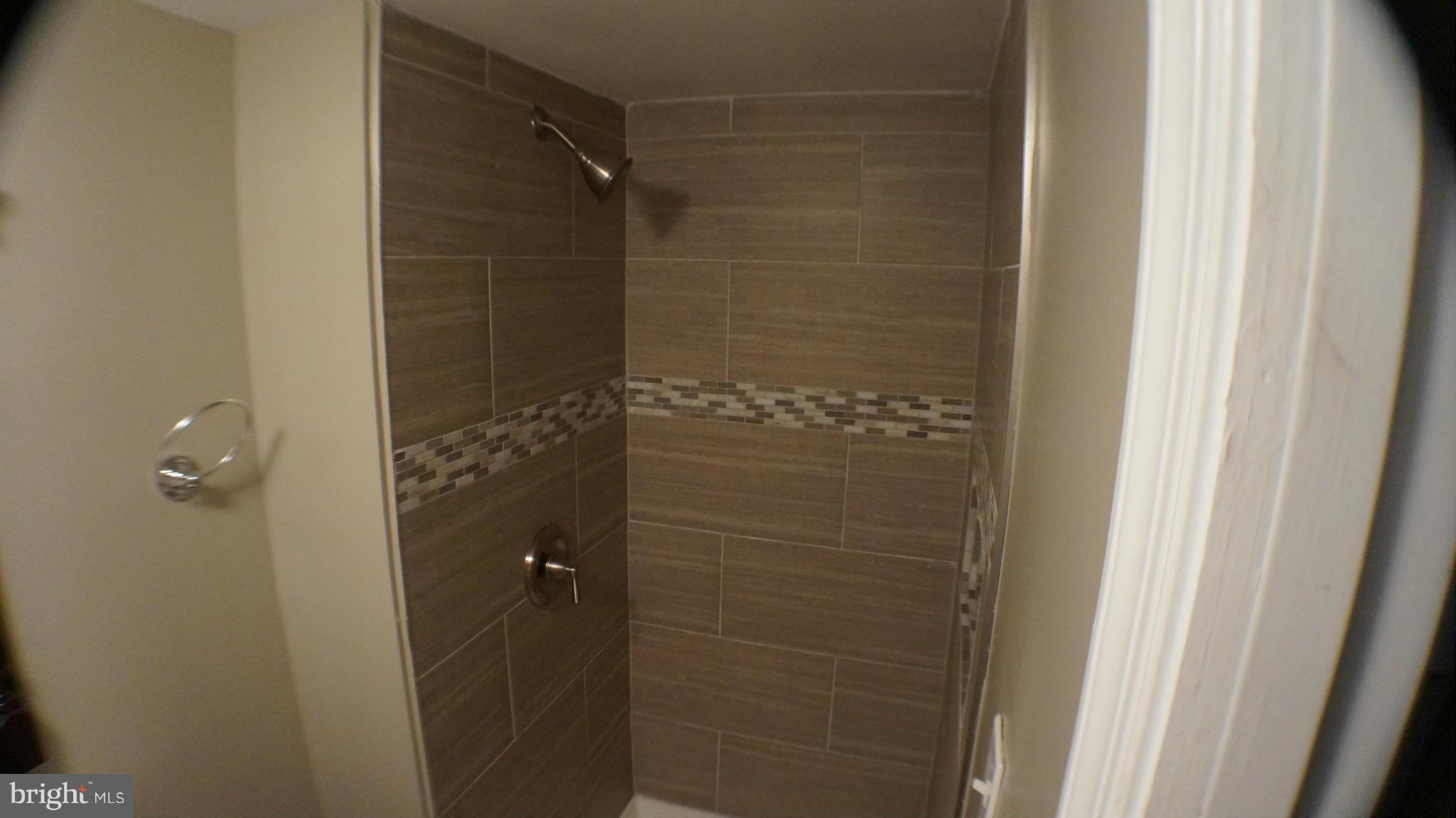 1233 Kevin Road Baltimore, MD 21229 - Photo 10 of 22 a bathroom with a glass door shower
