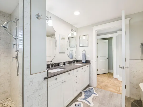a bathroom with a granite countertop sink mirror and shower