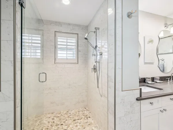 a bathroom with a granite countertop shower mirror and a sink