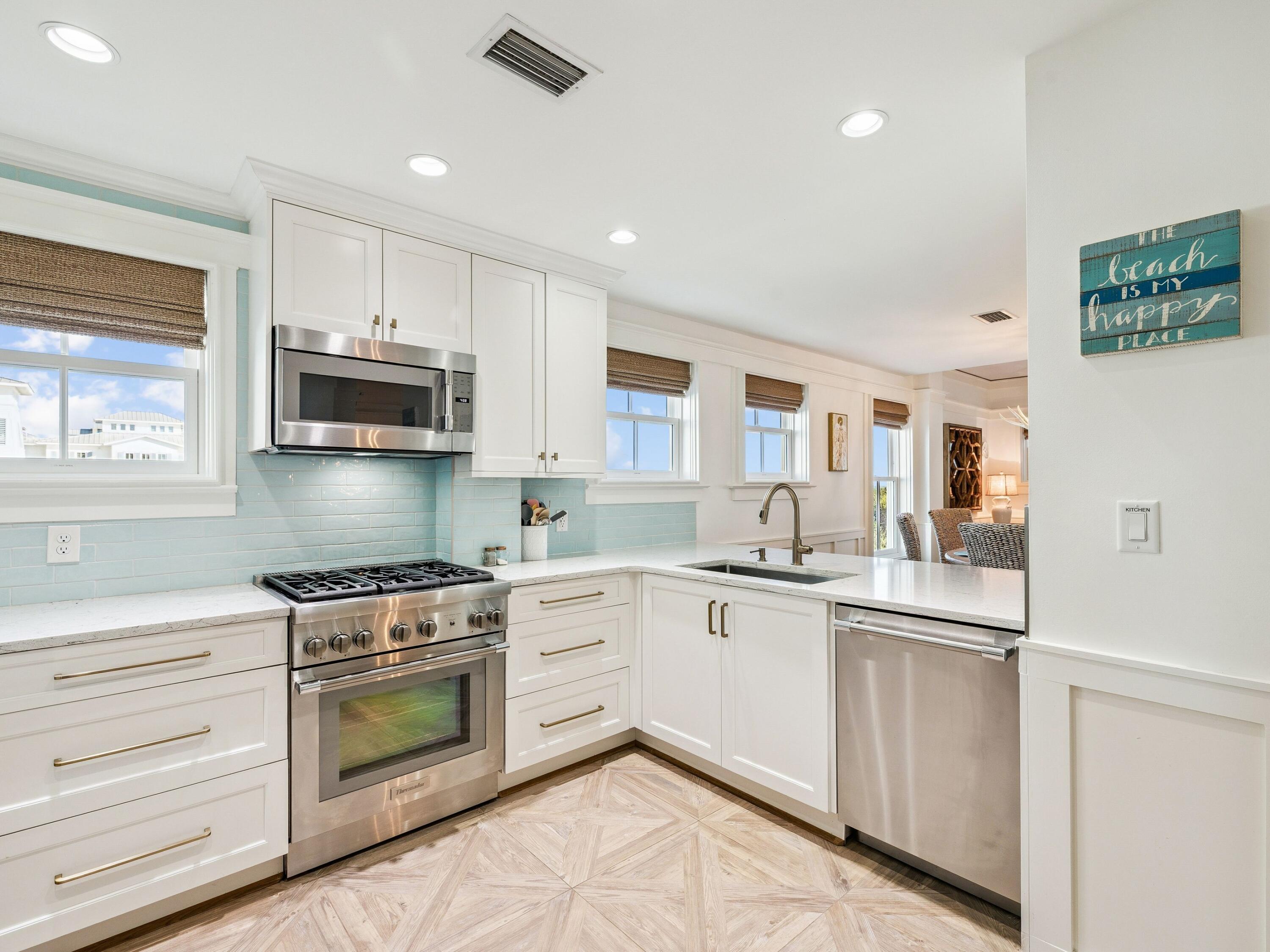 1848 East County Highway 30A, Unit 2 Santa Rosa Beach, FL 32459 - Photo 23 of 37 a kitchen with white cabinets stainless steel appliances and sink