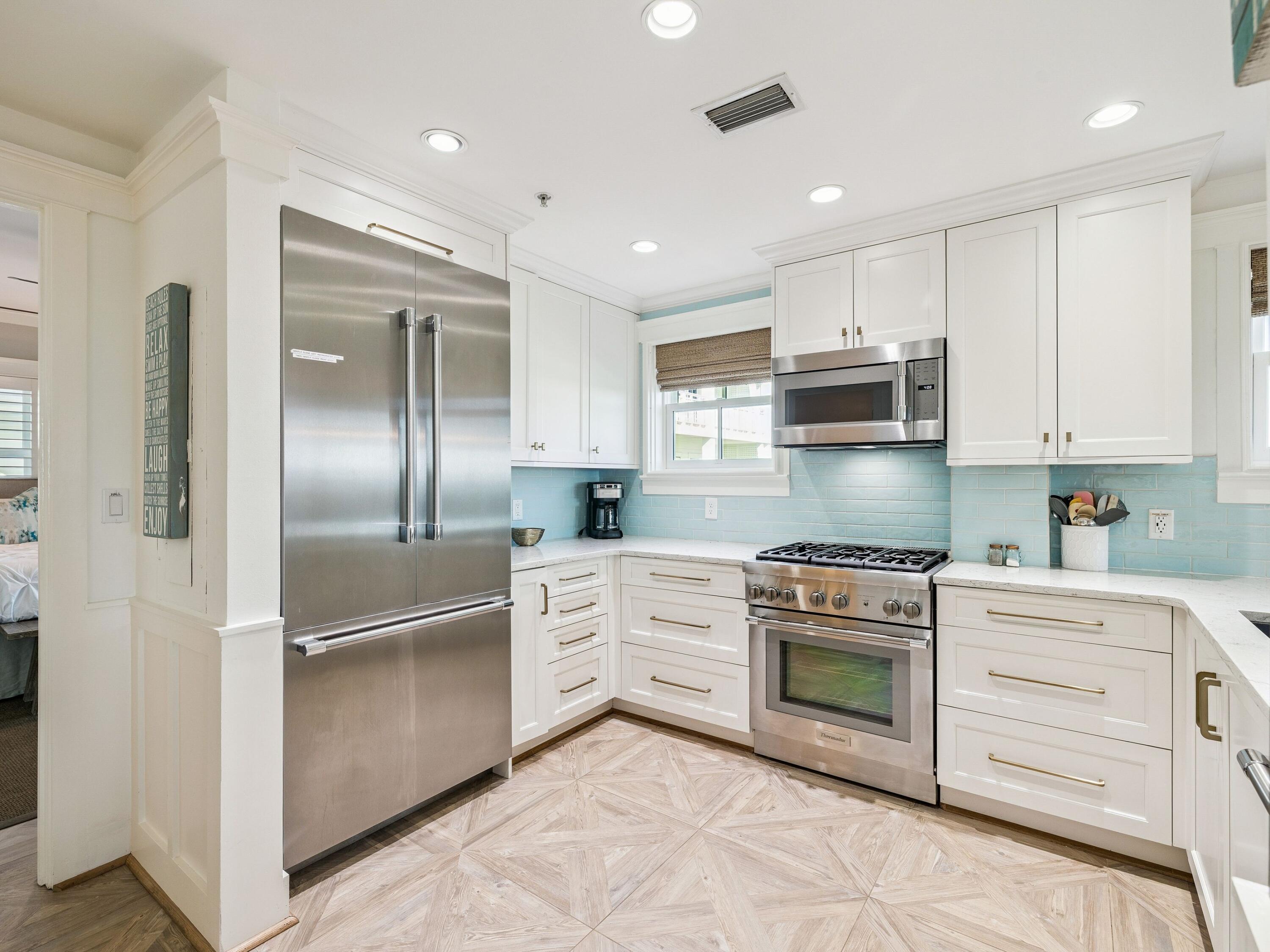 1848 East County Highway 30A, Unit 2 Santa Rosa Beach, FL 32459 - Photo 24 of 37 a kitchen with stainless steel appliances granite countertop a refrigerator a stove and a sink