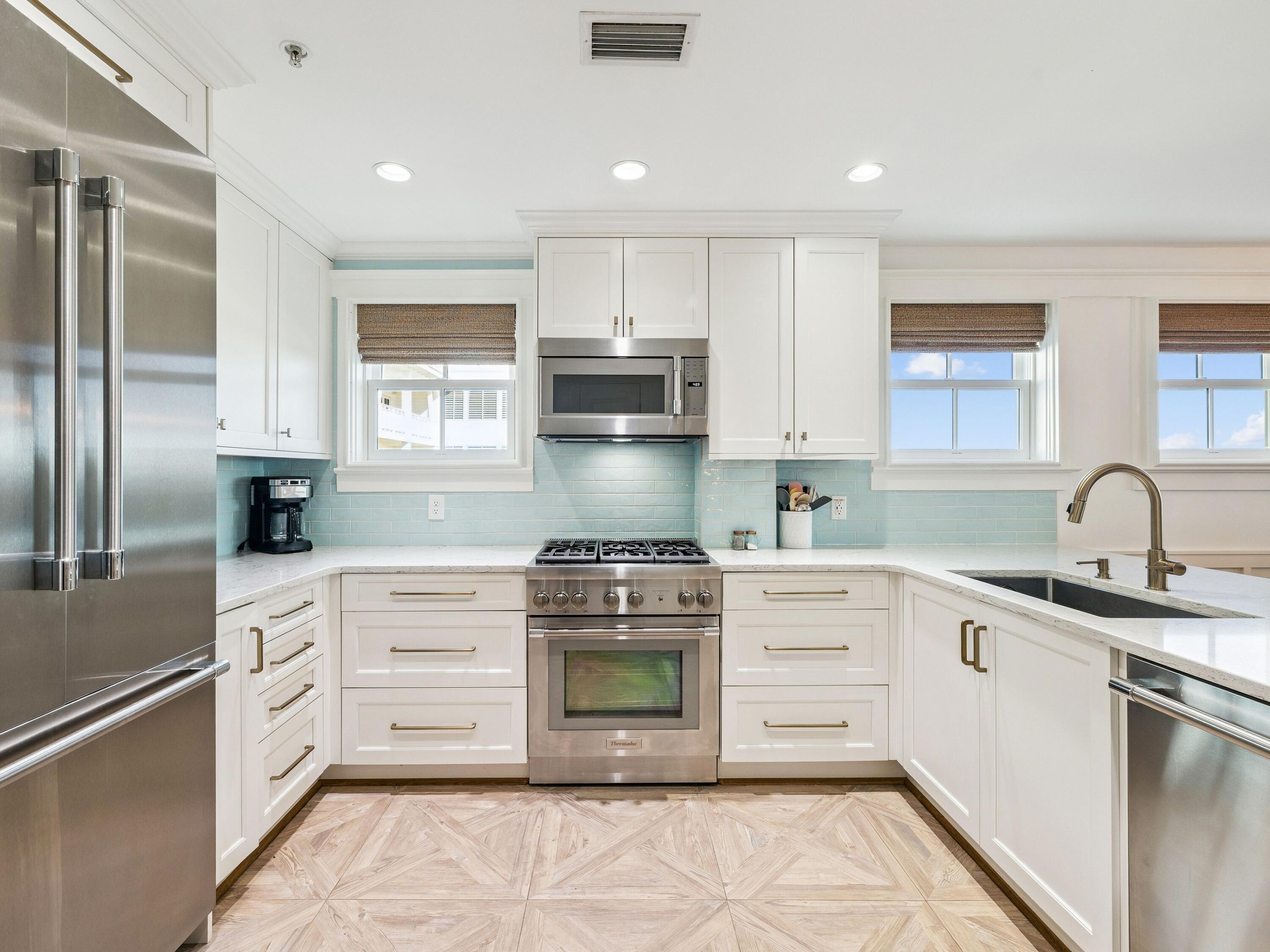 1848 East County Highway 30A, Unit 2 Santa Rosa Beach, FL 32459 - Photo 25 of 37 a kitchen with stainless steel appliances granite countertop a stove a sink and a refrigerator