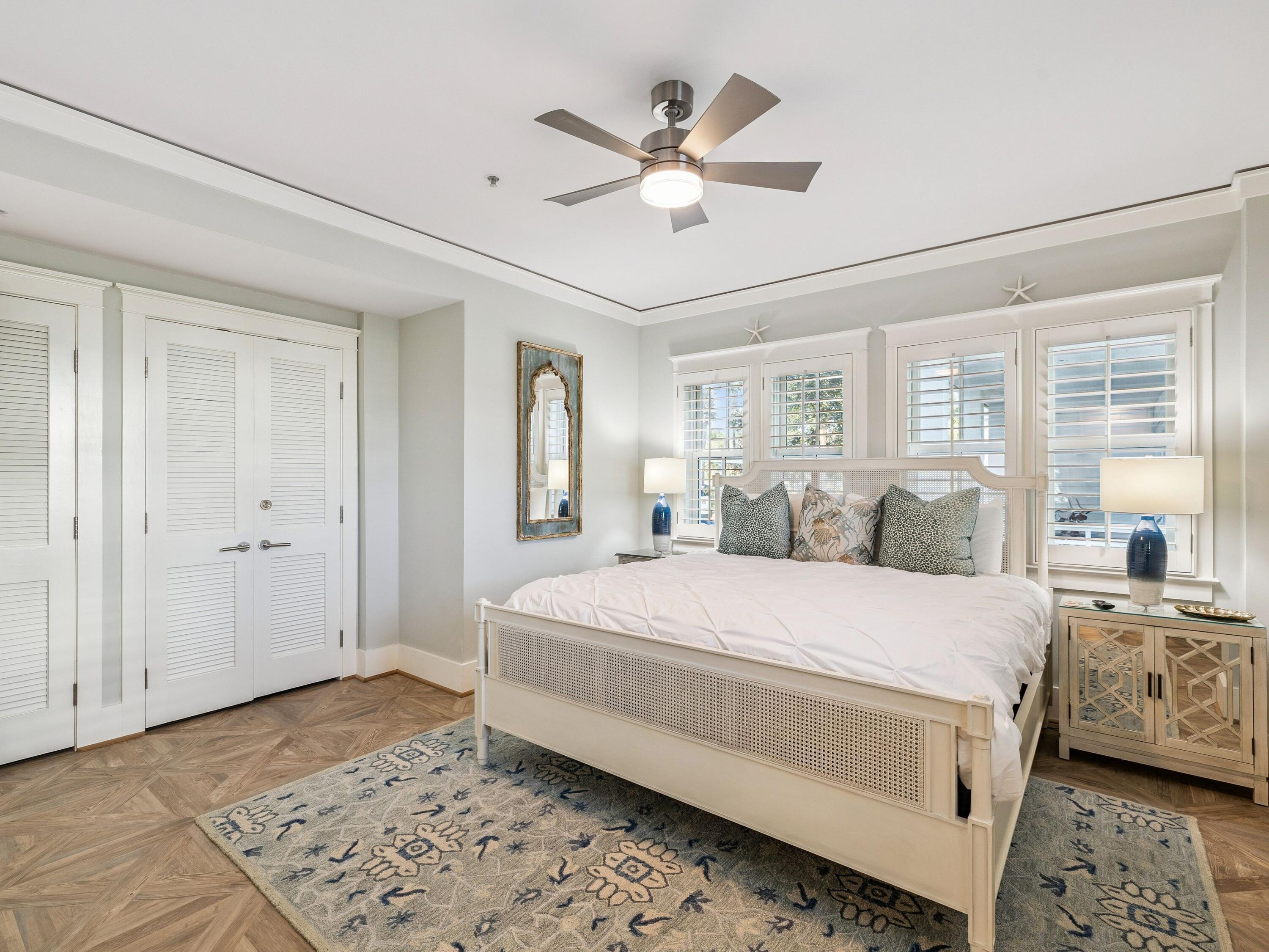 1848 East County Highway 30A, Unit 2 Santa Rosa Beach, FL 32459 - Photo 32 of 37 a room with a large bed and a chandelier fan