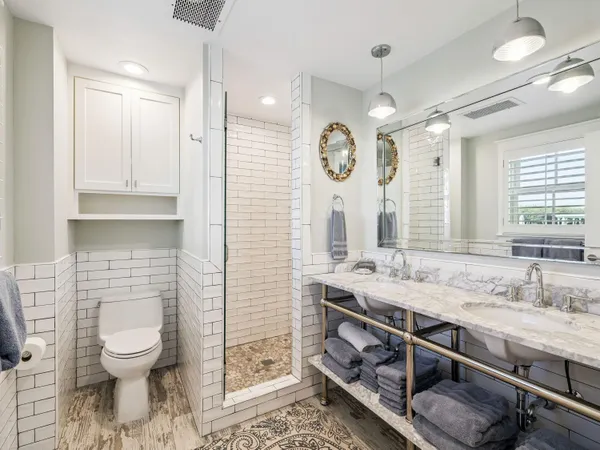 a bathroom with a sink a toilet and a mirror