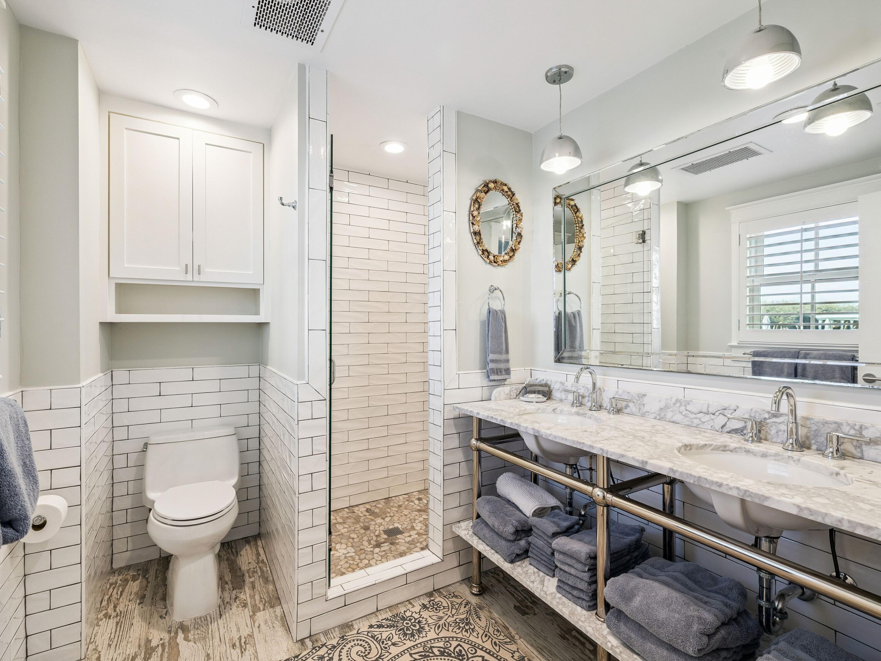 1848 East County Highway 30A, Unit 2 Santa Rosa Beach, FL 32459 - Photo 33 of 37 a bathroom with a sink a toilet and a mirror