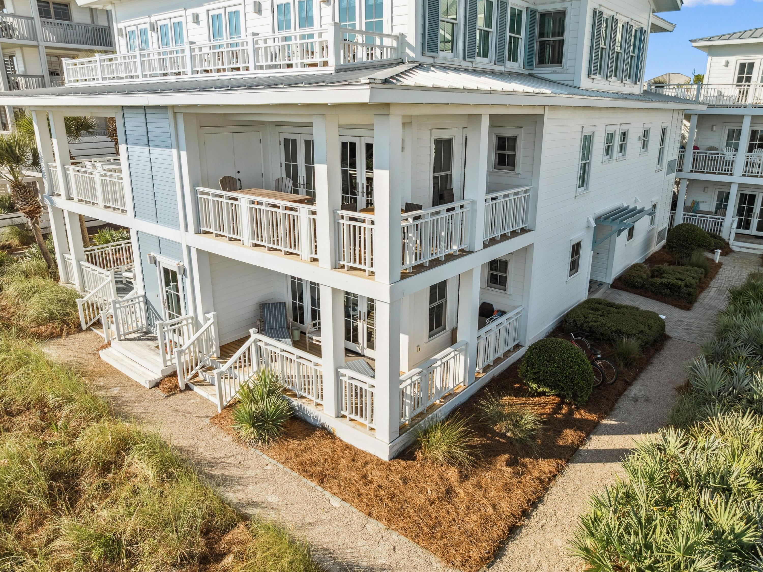 1848 East County Highway 30A, Unit 2 Santa Rosa Beach, FL 32459 - Photo 5 of 37 a view of a white building with large windows