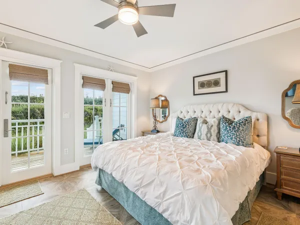 a bedroom with a large bed and a chandelier