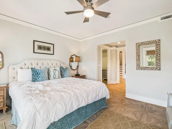 a bedroom with a bed and a chandelier