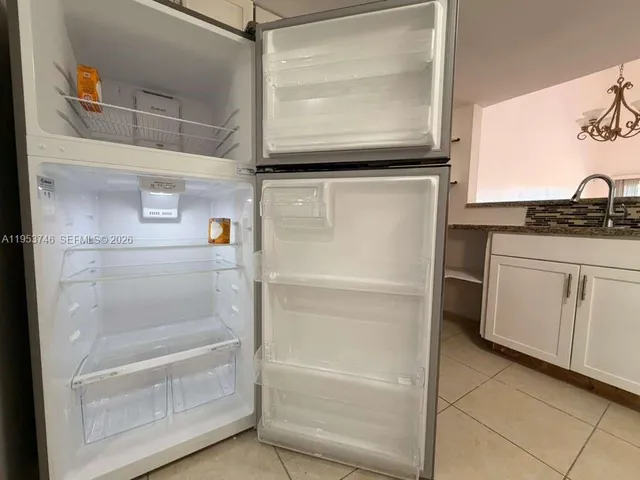 a refrigerator freezer sitting inside of a kitchen