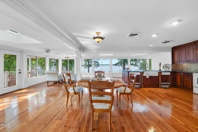 a living room with furniture and a flat screen tv with wooden floor
