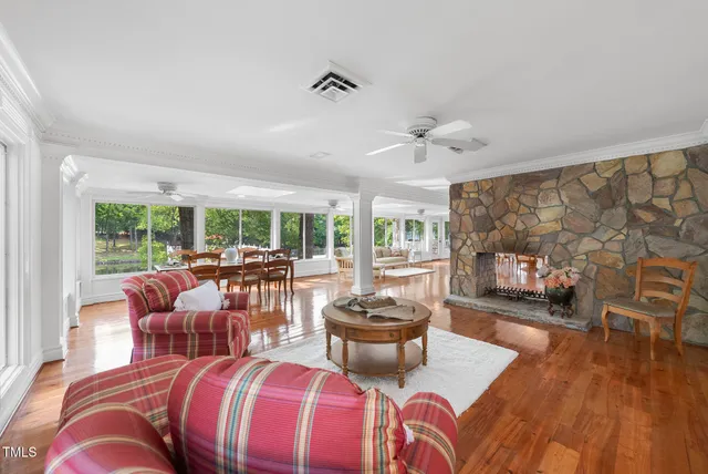 a living room with furniture a window and a chandelier