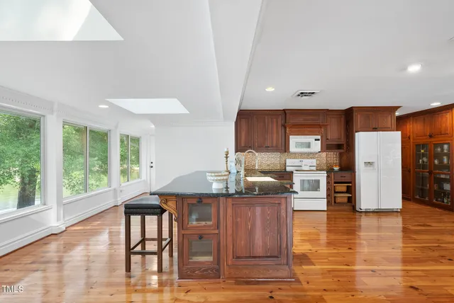 a view of a lake with table and chairs