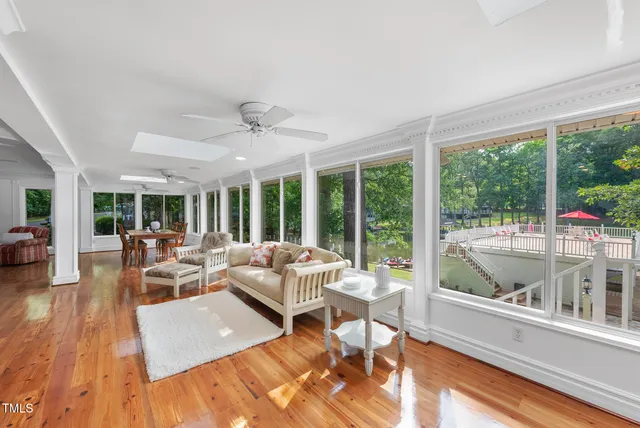 a view of a patio with table and chairs potted plants and large tree