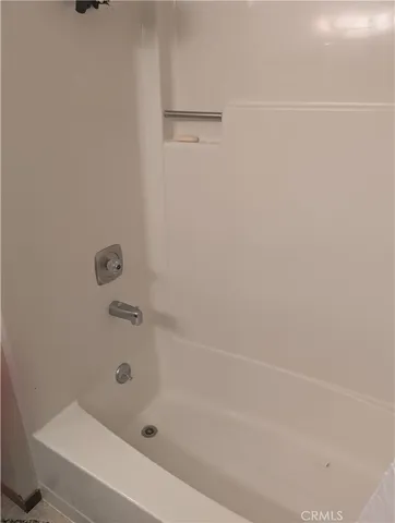 a bathroom with a shower and a bath tub