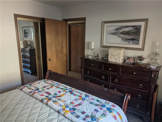 a bedroom with a bed and a dresser