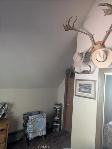 a view of a room that has a bed and a chandelier