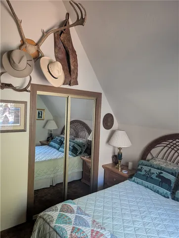 a bedroom with a bed and a mirror