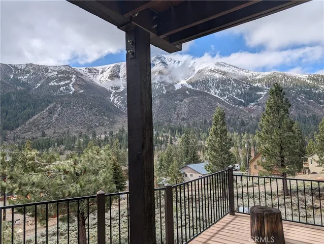 a view of a balcony with a yard