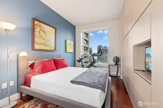 a bedroom with a large bed and a chandelier