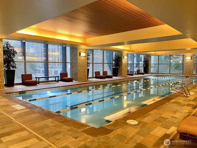 a view of a kitchen with a large pool table and chairs