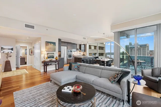 a living room with furniture and a wooden floor