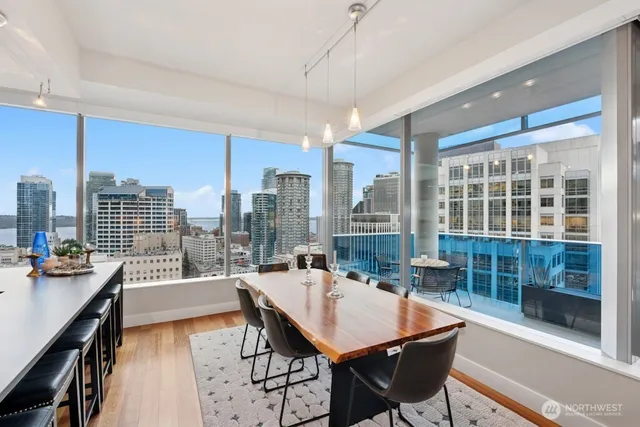 a dining room with furniture and a floor to ceiling window
