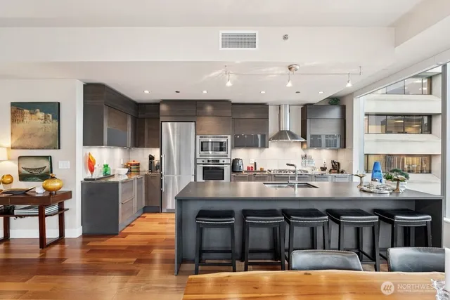 a kitchen with stainless steel appliances granite countertop a stove and cabinets