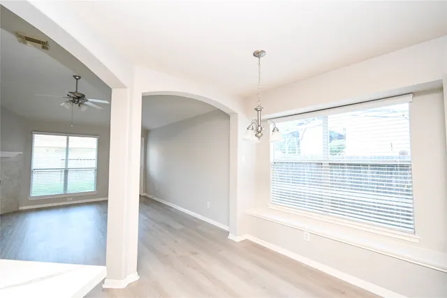 a large kitchen with stainless steel appliances kitchen island granite countertop a stove a sink dishwasher and a wooden cabinets