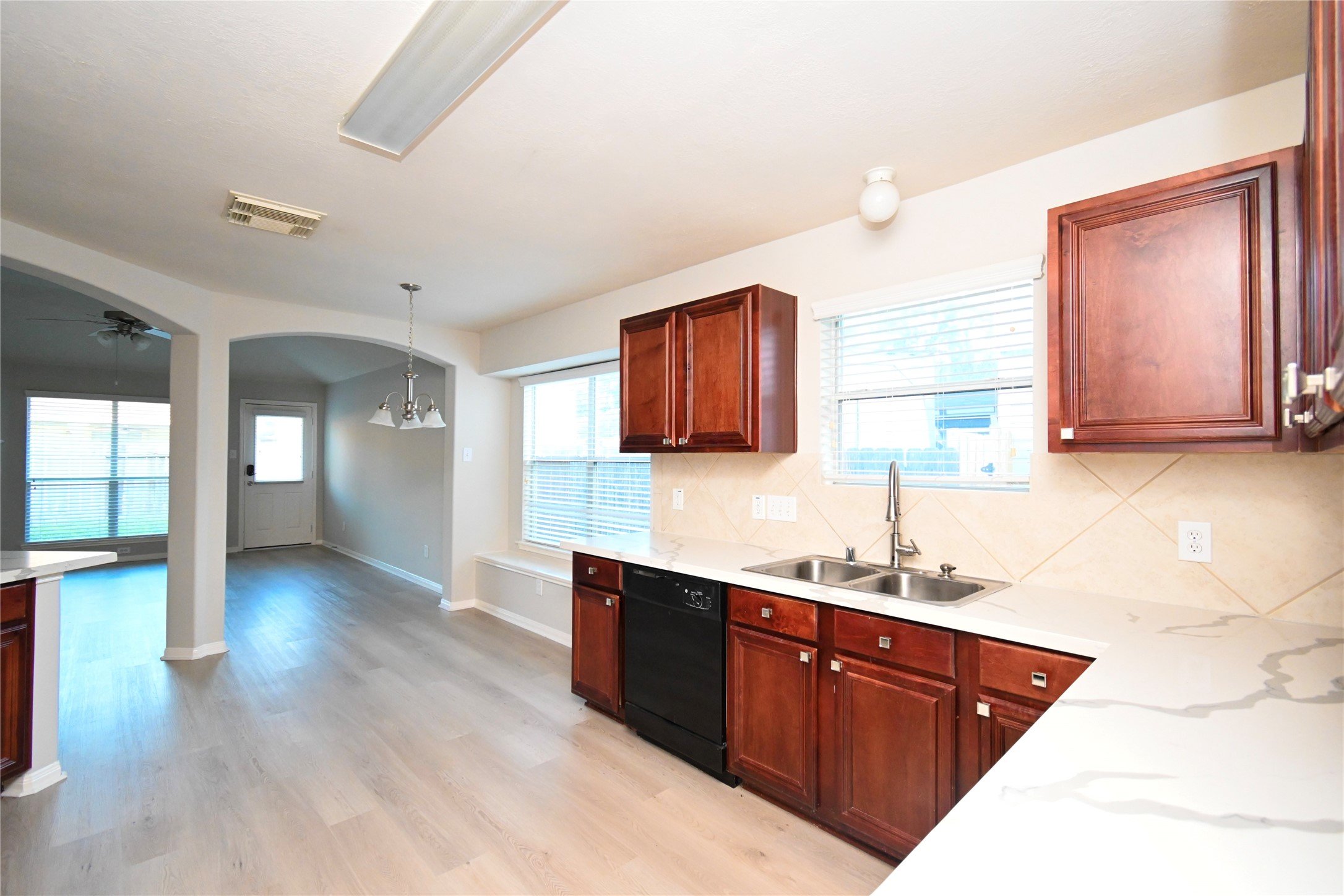 3111 Myrtle Ranch Drive Katy, TX 77494 - Photo 15 of 27 a kitchen with stainless steel appliances kitchen island granite countertop a sink dishwasher stove and cabinets with wooden floor