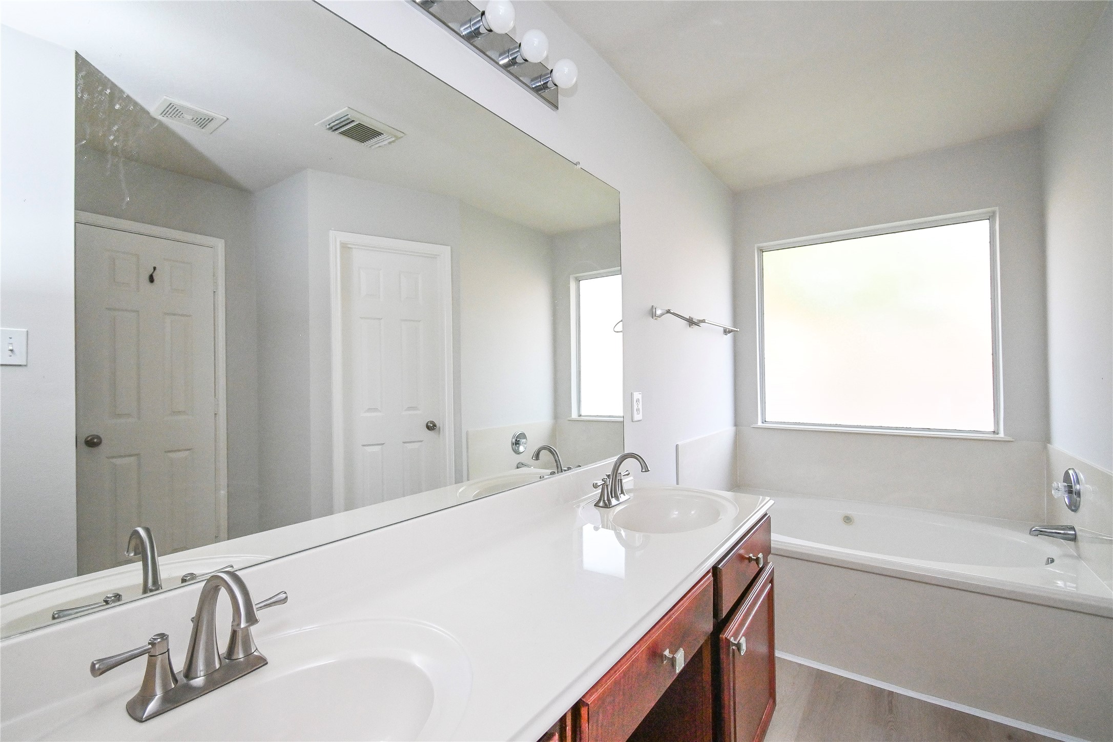 3111 Myrtle Ranch Drive Katy, TX 77494 - Photo 20 of 27 a bathroom with a double vanity sink window and a mirror