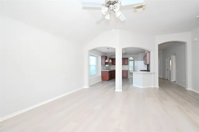 a view of a kitchen with furniture and an empty room