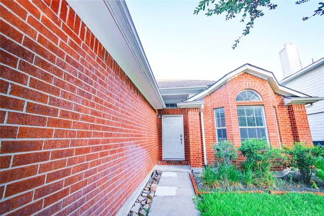 a view of a brick house with a large windows