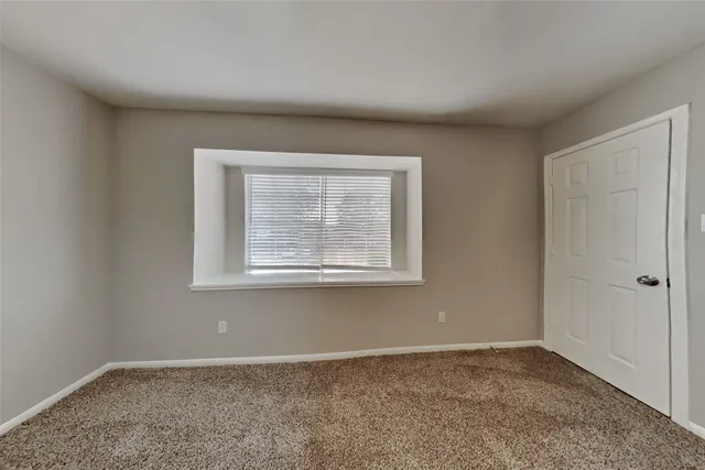 a bathroom with a granite countertop sink a toilet and a mirror