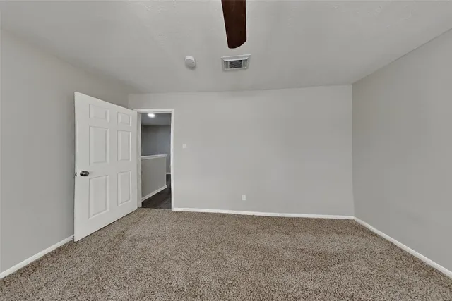 a white toilet sitting next to a bath tub