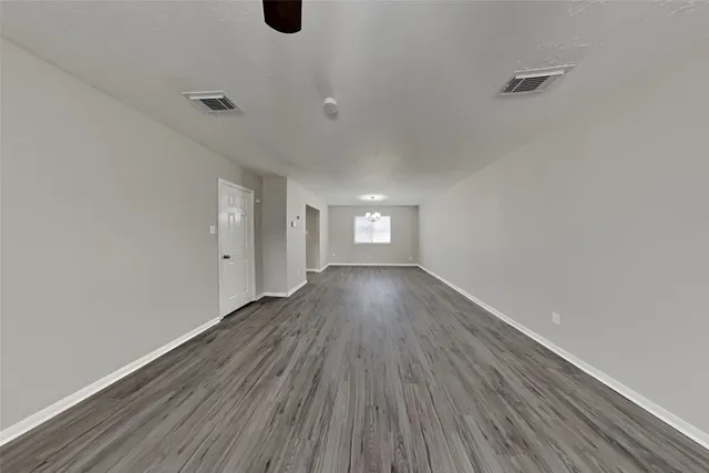 a view of wooden floor and windows in a room