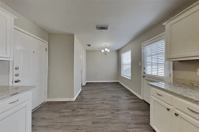 a view of a room with wooden floor and window
