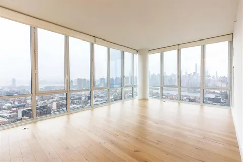 a view of an empty room and wooden floor