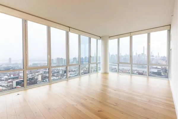 a view of an empty room and wooden floor