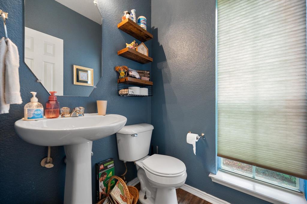 308 Faith Court Burleson, TX 76028 - Photo 17 of 40 a bathroom with a toilet sink and mirror