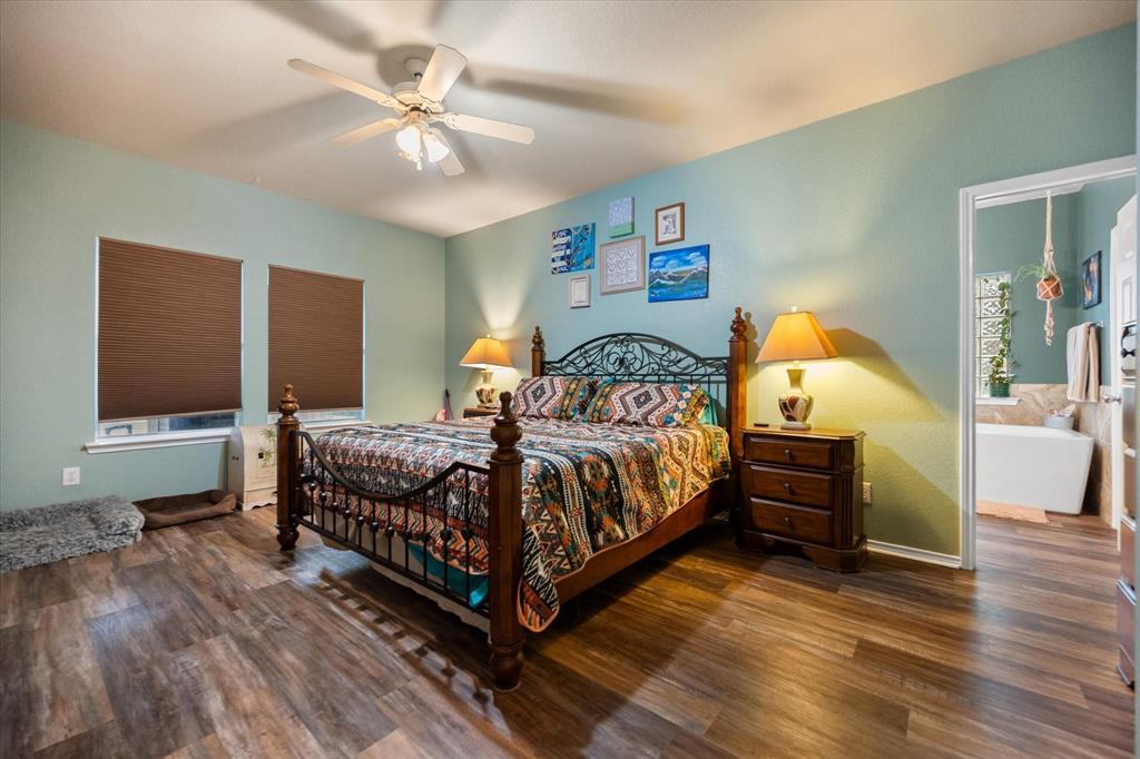 308 Faith Court Burleson, TX 76028 - Photo 19 of 40 a bedroom with a bed and wooden floor