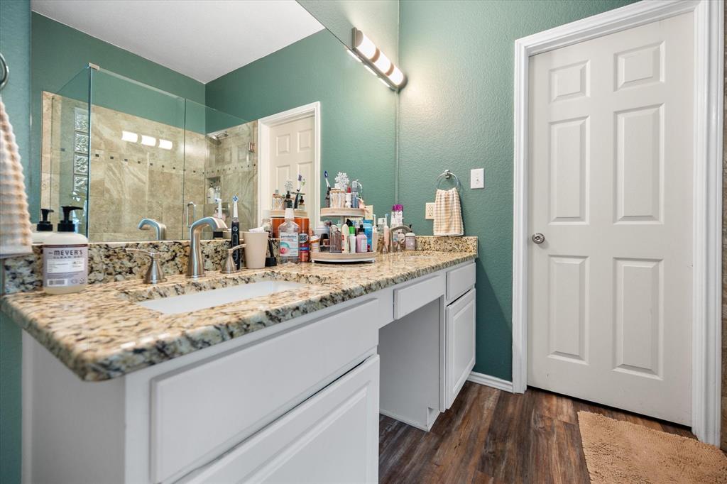 308 Faith Court Burleson, TX 76028 - Photo 21 of 40 a bathroom with a granite countertop sink and a mirror